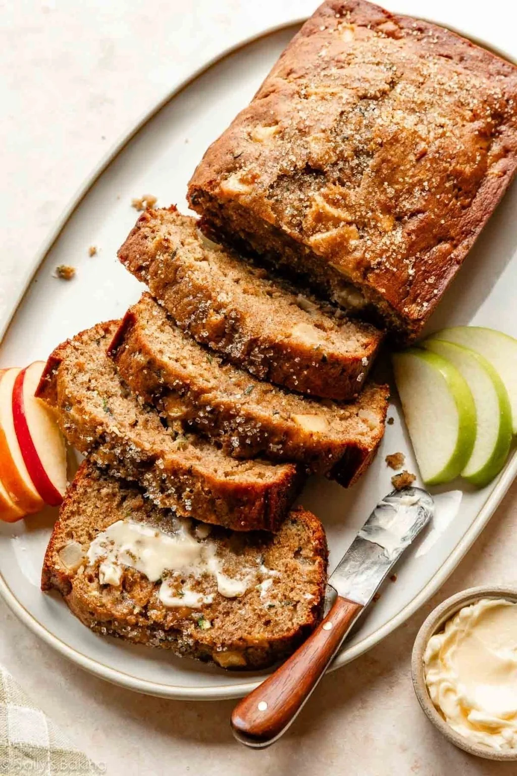 Slice of Apple Zucchini Bread on a plate with fresh apples